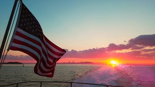 Close-up of flag against sky during sunset