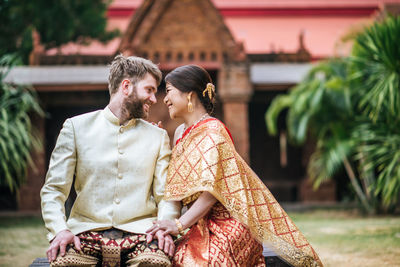 Young couple sitting outdoors