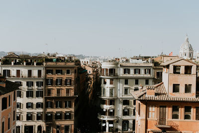 Buildings in city against clear sky