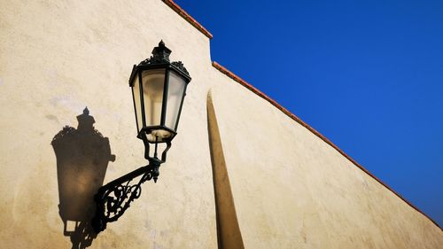 Low angle view of street light against building