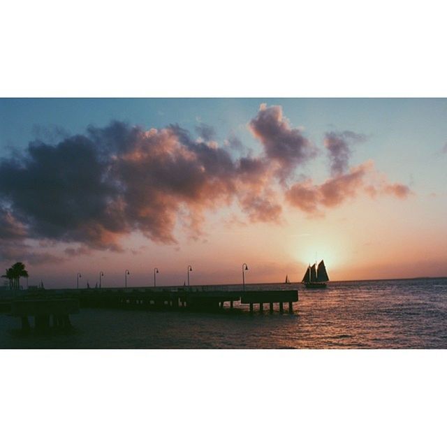 water, sunset, sky, sea, transfer print, tranquil scene, auto post production filter, tranquility, scenics, pier, cloud - sky, beauty in nature, nature, transportation, nautical vessel, waterfront, silhouette, horizon over water, idyllic, boat