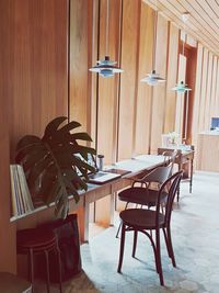 Empty chairs and table against wall at home