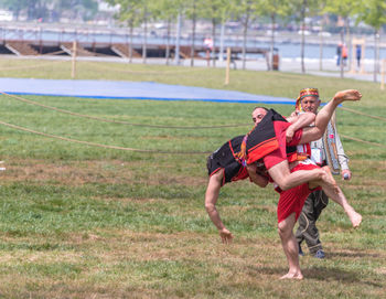 Full length of men playing on field