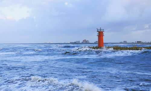 Scenic view of sea against cloudy sky