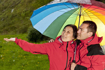 Couple enjoying a walk in the rain in england