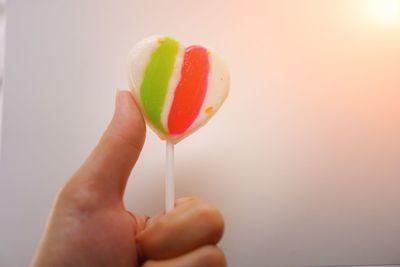 Close-up of hand holding strawberry