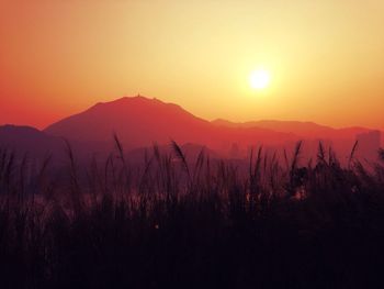 Scenic view of silhouette mountains against sky during sunset