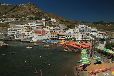 High angle view of townscape by sea against sky