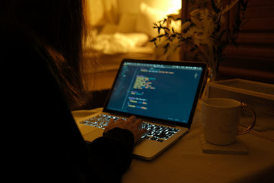 Man using laptop on table at home