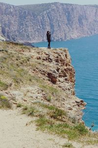 Rear view of man walking on mountain