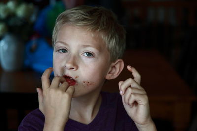 Boy licking chocolate off his fingers