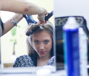 Portrait of young woman looking at camera