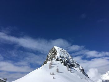 Low angle view of snowcapped mountain against sky