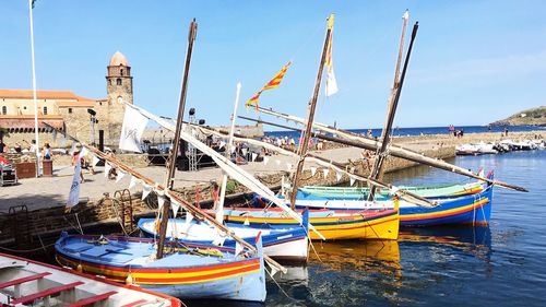 Boats moored in sea against sky