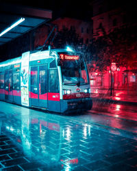 Illuminated city by street at night