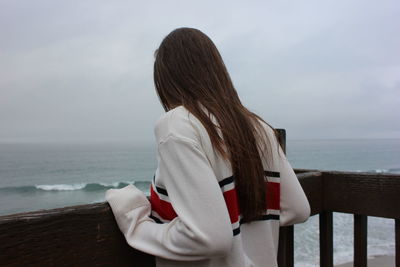 Rear view of woman at seaside