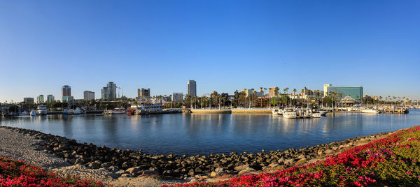 Panoramic view of sea and buildings against clear blue sky