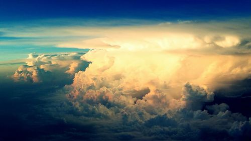 Scenic view of mountains against cloudy sky