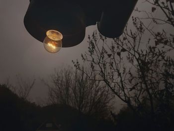 Low angle view of illuminated lamp against sky