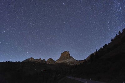 Scenic view of mountains against sky at night