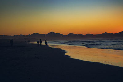 Scenic view of beach against sky during sunset