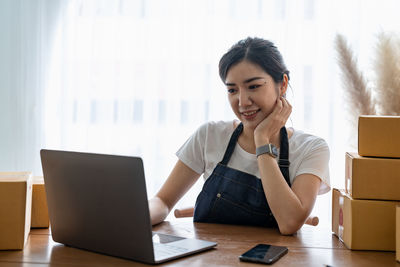 Businesswoman using laptop at office