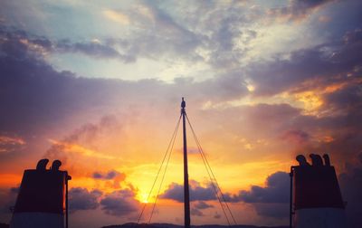 Silhouette pole against sky during sunset