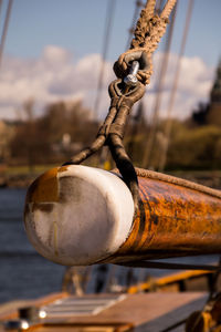 Close-up of rusty chain against sky