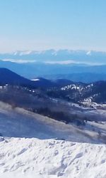 Scenic view of snow covered mountains against sky