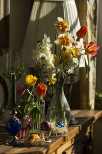 Spring flowers in a vase on the dresser in sunlight