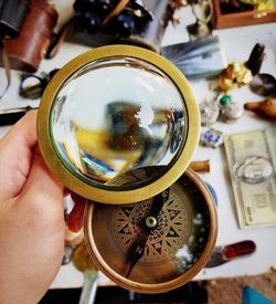 Close-up of person holding cup on table