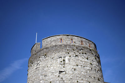 Low angle view of tower against blue sky