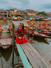 Portrait of woman on boat against river