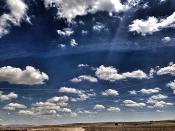 Scenic view of landscape against cloudy sky