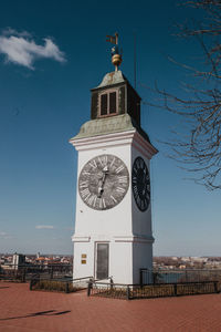 Low angle view of clock tower against building