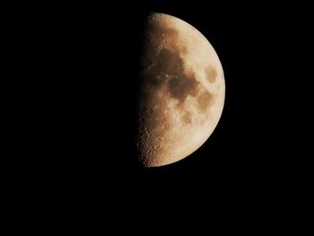 Low angle view of moon in the dark