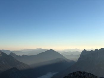 Scenic view of mountains against clear sky during sunset