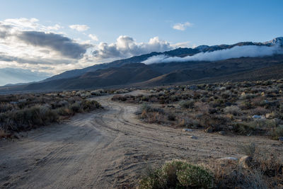 Dirt road in the desert heading to eastern sierra nevada mountains of california usa