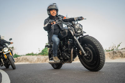 Man riding motorcycle on road