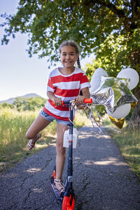 Portrait of smiling young woman walking on road