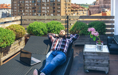 Panoramic shot of men sitting in city