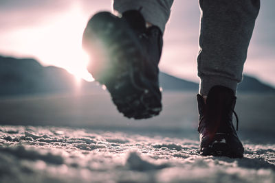 Low section of person wearing shoes on land