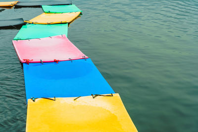 High angle view of multi colored umbrellas on lake