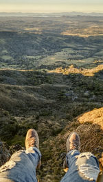 Low section of man standing on mountain