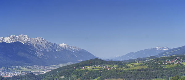 Scenic view of snowcapped mountains against clear blue sky