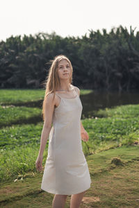 Young woman standing on field