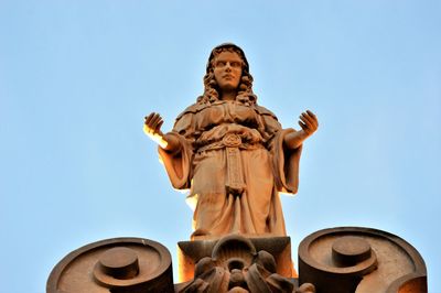 Low angle view of statue against sky