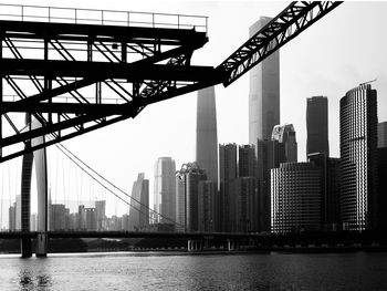 View of bridge over river against buildings in city