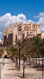 Palm trees and cathedral against sky