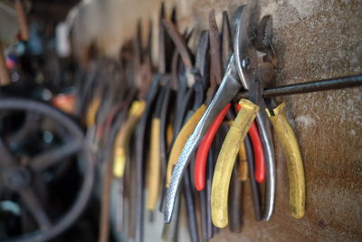 Close-up of clothespins hanging on clothesline against wall